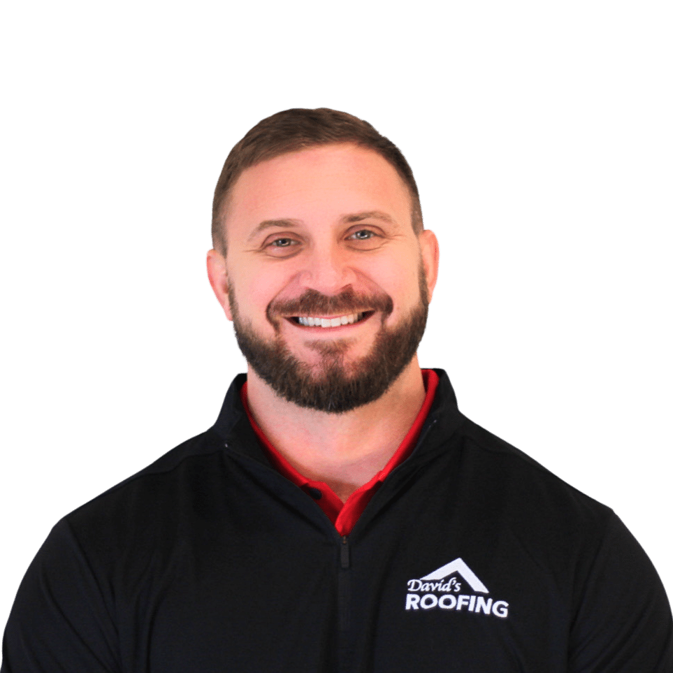 Smiling man with a beard wearing a black vest with "David's Roofing" logo.