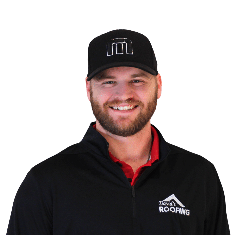 A man with a beard smiles, wearing a black cap and a black jacket with "David's Roofing" logo on it.