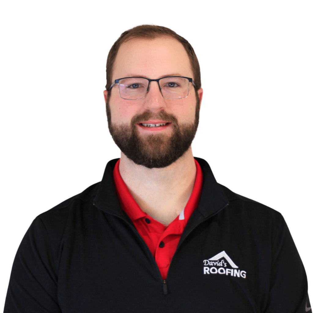 Man with glasses and beard, wearing a black jacket with "David's Roofing" logo and a red shirt, standing against a plain background.