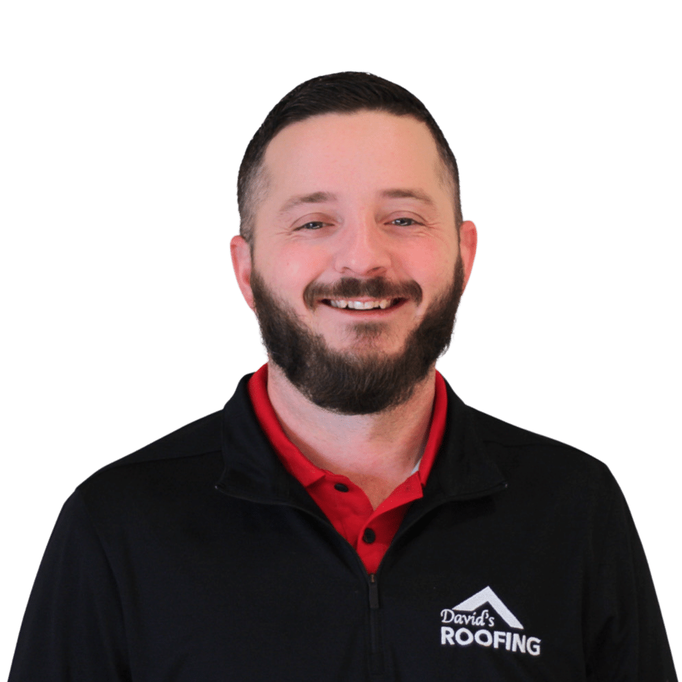 A man with a beard smiles at the camera, wearing a black jacket with a "David's Roofing" logo and a red shirt, set against a plain green background.