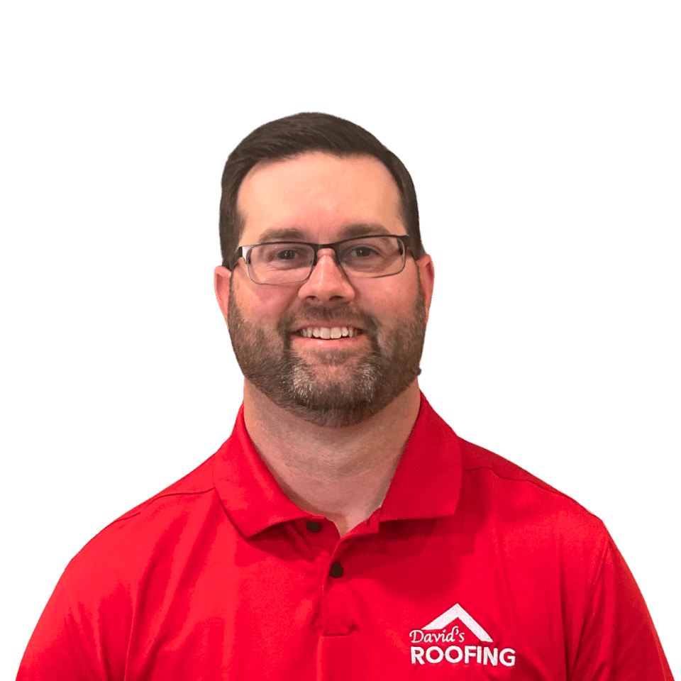 A man wearing glasses and a red polo shirt with the "David's Roofing" logo, smiling in front of a plain black background.