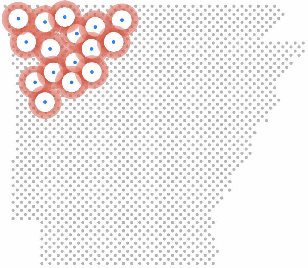 A cluster of red and white donut-shaped icons with blue centers arranged in the top left corner of a pixelated gray grid shaped like Arkansas.