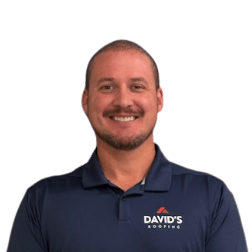 A man with short hair and a beard, wearing a navy blue polo shirt with "DAVID'S ROOFING" logo, smiles at the camera against a plain white background.