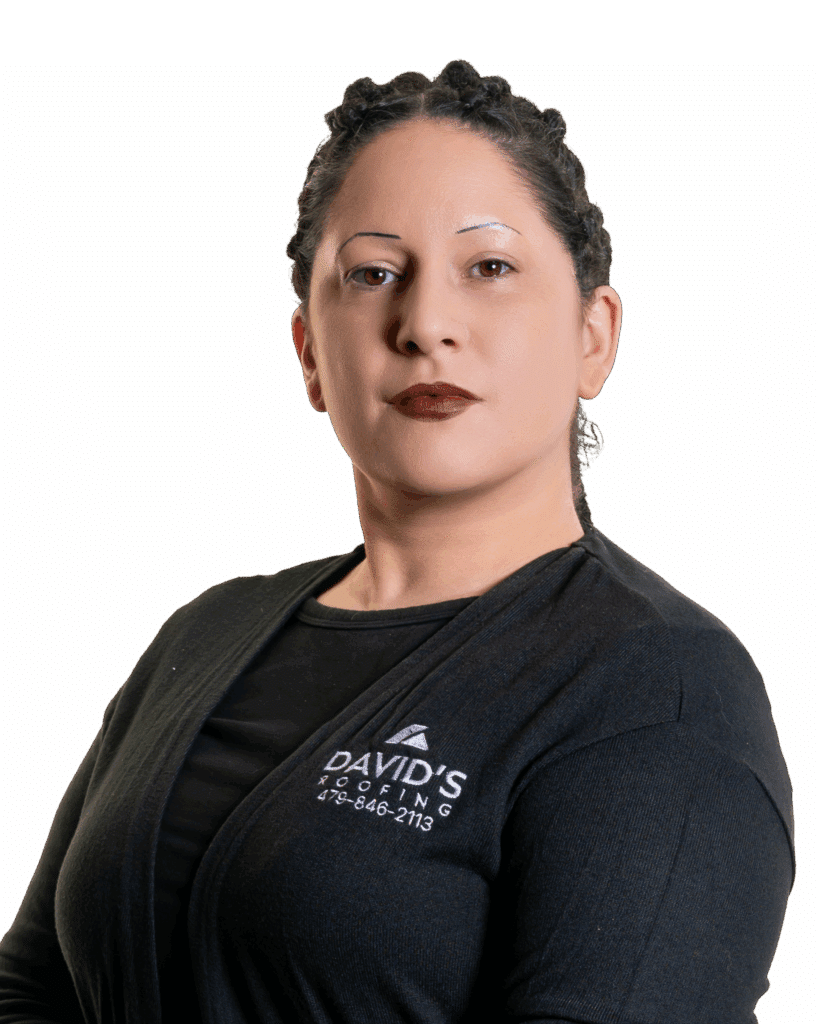 Person with braided hair, wearing a black David's Roofing shirt, poses against a plain white background.