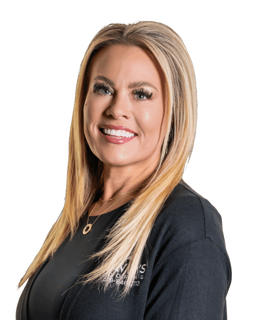 Woman with long straight blonde hair, wearing a black top and gold necklace, smiling at the camera against a plain white background.