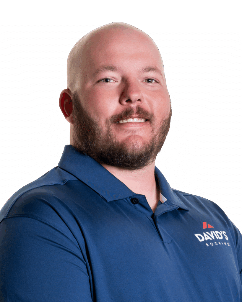 A man with a shaved head and beard wearing a blue polo shirt with "DAVID'S ROOFING" logo, standing against a plain white background.