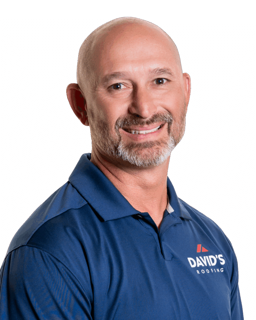 A man with a bald head and trimmed beard, wearing a blue polo shirt with the "David's Roofing" logo, smiles at the camera against a white background.