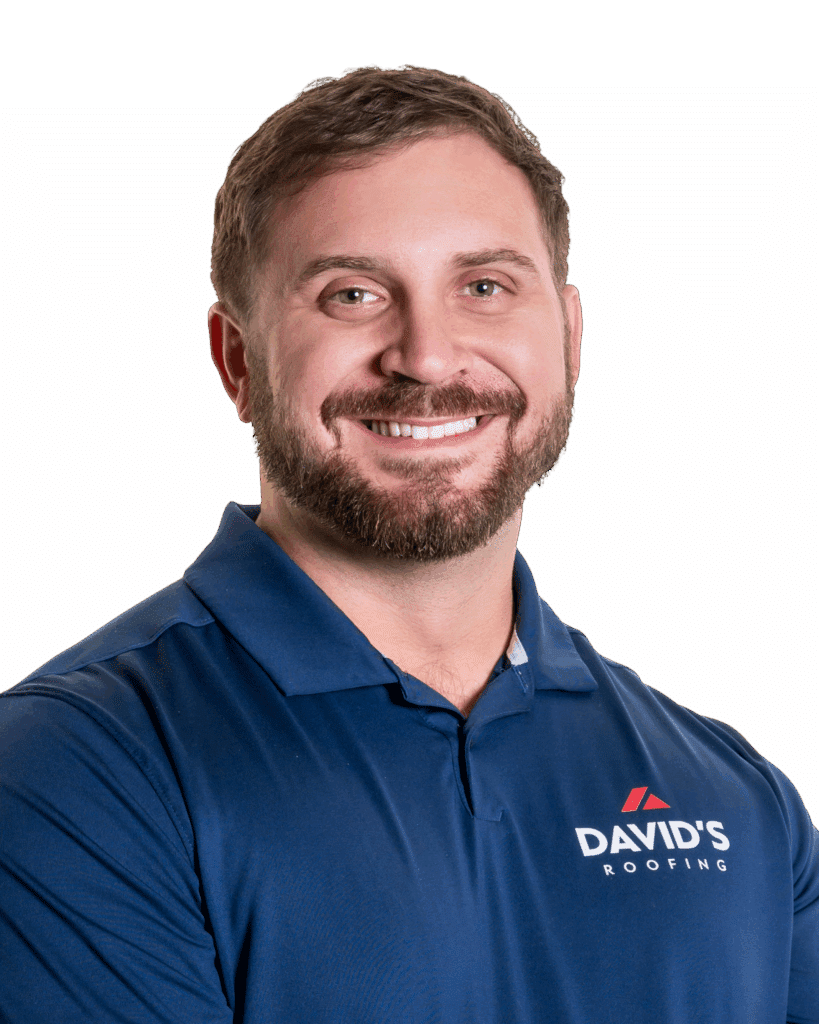 A man with short brown hair and a beard, smiling, wearing a navy blue polo shirt with the "David's Roofing" logo.