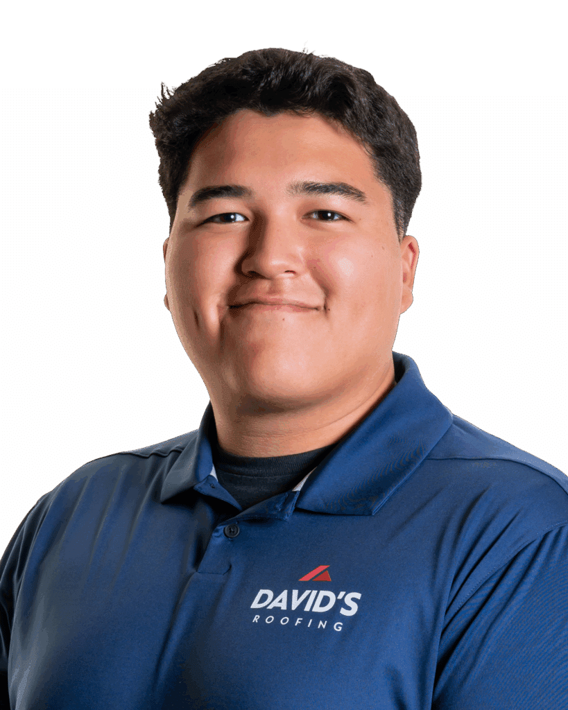 A young man with short dark hair wearing a blue "David's Roofing" polo shirt, standing against a plain white background.