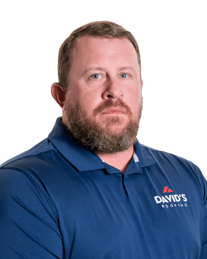 A man with a beard wearing a blue "David's Roofing" polo shirt stands against a plain white background.